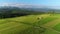 Trailer Caravaning in the mountains. Aerial view of RV car with trailer caravan, parked in the middle of mountain meadow