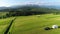 Trailer Caravaning in the mountains. Aerial view of RV car with trailer caravan, parked in the middle of mountain meadow