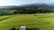 Trailer Caravaning in the mountains. Aerial view of RV car with trailer caravan, parked in the middle of mountain meadow