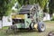 Trailer with a mechanism for creating bales of hay