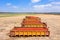 Trailers loaded with Fresh picked Tomatoes parked in an agricultural field.