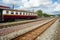 Train bogies on train tracks at Thai train stations on a clear day.