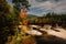 Train bridge over a river and autumn color near Bethel, Maine.