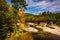 Train bridge over a river and autumn color near Bethel, Maine.