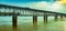 Train and bus passes through road cum railway bridge over the Godavari river at sunset, Rajahmundry,  India