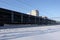 The train carries large pipes for the pipeline. Winter. Snow from under the wheels. The effect of movement. Russia. Moscow region