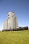 Train cars parked on tracks by an old grain elevator