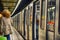 Train cars and passengers at the metro station