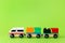 Train children toy, preschool kids game. Locomotive and carriages, wooden colorful blocks construction on green color
