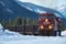 Train coming round the bend with Canadian Rockies in winter