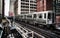 Train on elevated tracks within buildings at the Loop, Chicago City Center - Bleached Portrait Artistic Effect - Chicago, Illinois