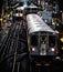 Train on elevated tracks within buildings at the Loop, Chicago City Center - Vintage Dark Deep Tonal Artistic Effect - Chicago, Il