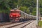 Train hauling waggons with cement. Freight train with a long series of cement carriages traveling on a curved stretch of a track