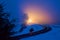 A train headlight pierces the dusk in Montana