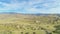 Train and Hilly Green Farmland. Kern County. California, USA. Aerial View