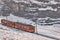 Train in Kleine Scheidegg under Eiger, Monch and Jungfrau peaks in Swiss Alps, Berner Oberland, Grindelwald,