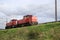 Train locomotives 6412 in red color of DB on railroad track at Nieuwerkerk aan den IJssel in the Netherlands.