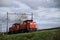 Train locomotives 6412 in red color of DB on railroad track at Nieuwerkerk aan den IJssel in the Netherlands.