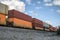 Train long freight passing with container loading on railway in valley