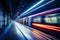 a train moving through a subway station at night