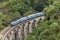 Train on Nine Arches bridge in hill country of Sri Lanka