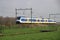 Train of the NS, dutch railways, sprinter on track between Gouda and Rotterdam at the meadows of Moordrecht