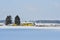 A train passing on a railroad on a winter day through a snowy landscape