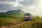 Train passing at sunset against the background of mountains