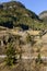 train passing under a chalet on a sunny slope near Wassen , Switzerland