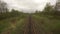 Train pov railway track, rails, view from moving train window landscape mountain village moody cinematic dramatic shot