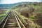 Train rails turn left in landscape