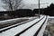 Train rails in winter season. Beautiful landscape of countryside. Rail track laid through forest.