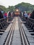 A train slowly crosses the famous bridge over the river kwai in