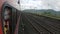 a train slowly moving and leaving a train platform in Konkan