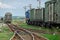 Train standing on siding on a sunny day in summer. Railway freight wagons and tanks of a different type and color