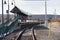 Train station platform with rural background of wooded hills