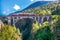 Train on the top one of Norway`s most famous railway bridges named Kylling bridge