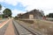 train tracks and a bluestone railway station building and platform