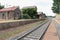 train tracks and a bluestone railway station buildings and platform