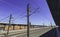 Train tracks and catenary and electric lines in a blue sky morning