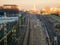 Train tracks of the city of Ponferrada in shadow, with the background illuminated at dawn