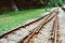 Train tracks on gravel, two of railways tracks merge in a rural scene background, concept of journey