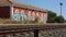 Train tracks next to an abandoned station, where you can appreciate the splendor of bygone days