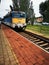 A train traveling down train tracks near a station