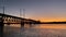 Train Travels Across a Bridge as Sun Sets