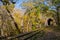 Train tunnels and railways in forest. Beautiful autumn landscape with a tunnel and a railway