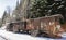 Train. Wagon. Wooden. Rusty. Snow. Winter. Forest. Hills
