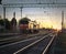 Train without wagons, locomotive on sunset background, railway and sun