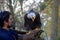 Trained bald eagle sits on its handler`s arm and calls with open beak