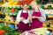 Trainee salesgirl listening attentively to experienced female colleague in greengrocery store